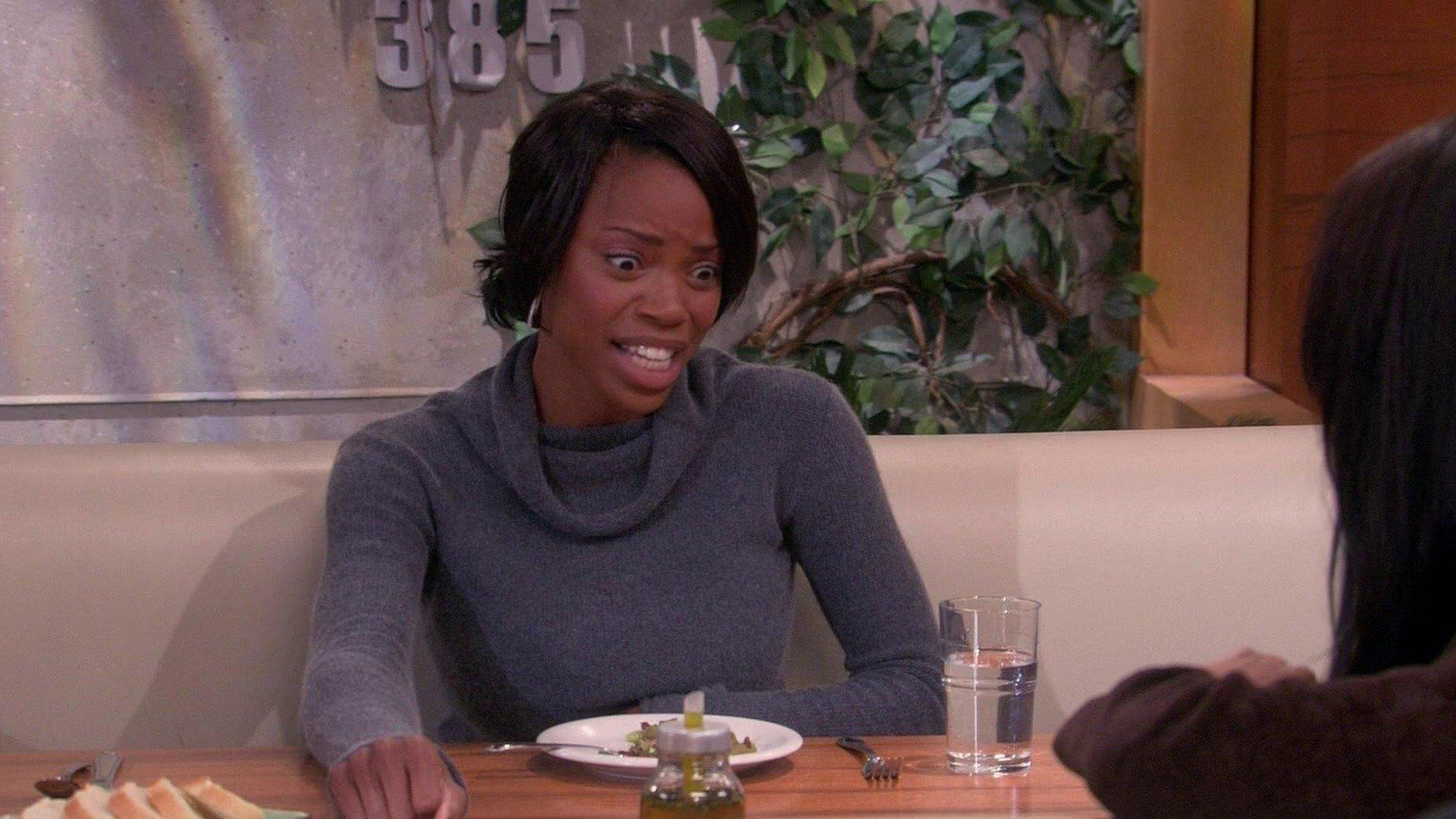 Toni looks panicked in a grey sweater at the cafe