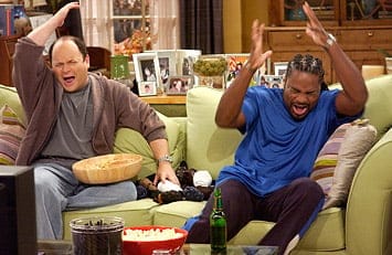 Jason Alexander (in brown and gray) and Malcolm Jamal-Warner (in a blue shirt) throw up their hands in dismay