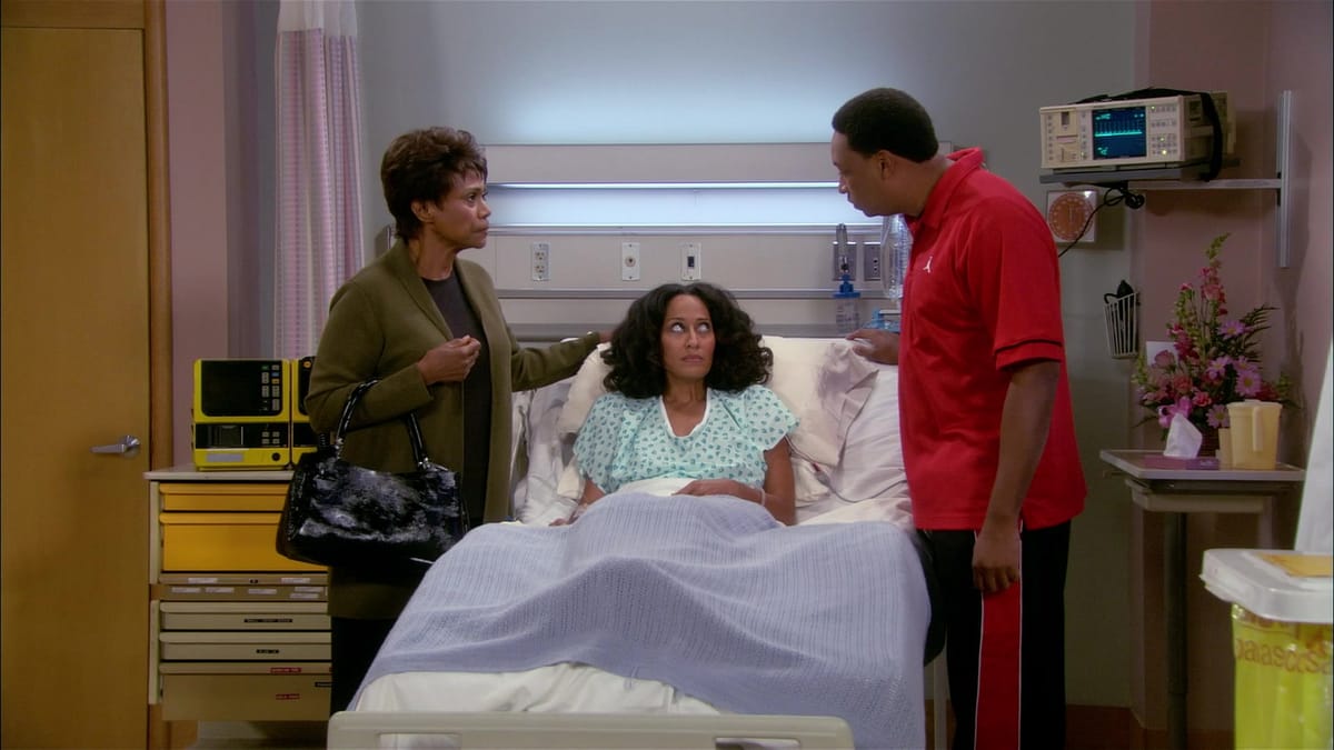 William and Joan's mom argue while Joan lies in her hospital bed