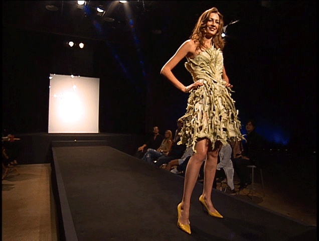 Blonde model on the runway in Austin Scarlett's design: a dress made of corn husks.