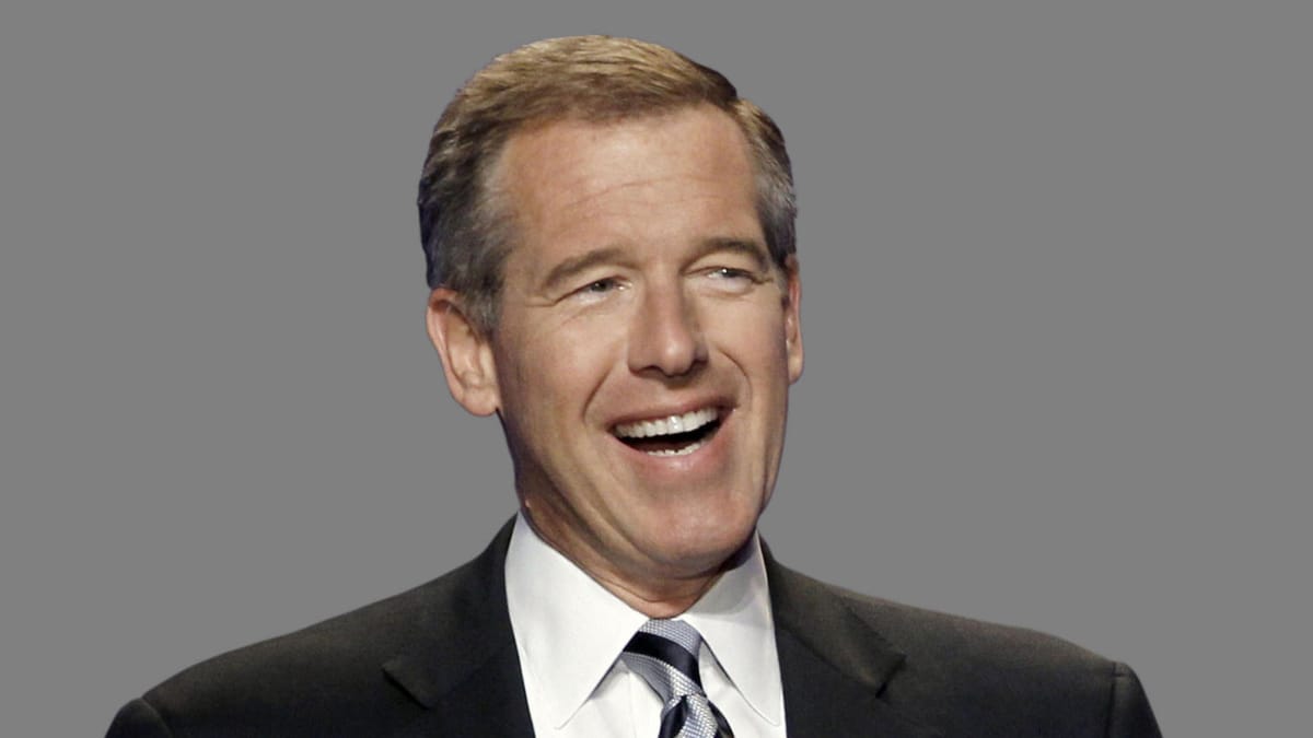 Brian Williams in a suit and tie, apparently mid-laugh,, against a gray background.