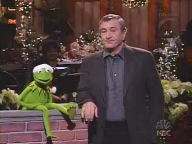 Kermit the Frog (left) and Robert De Niro (left) in a gray polo and black suit jacket