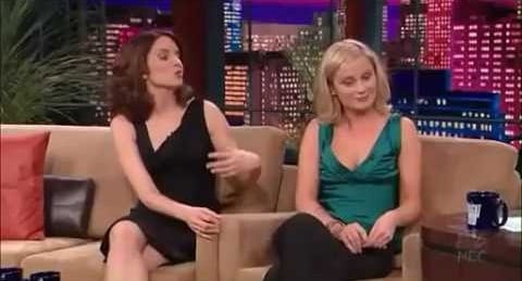 Tina Fey and Amy Poelher on the Tonight Show. Tina (left) wears a black dress, Amy (right) wears a green top and black pants