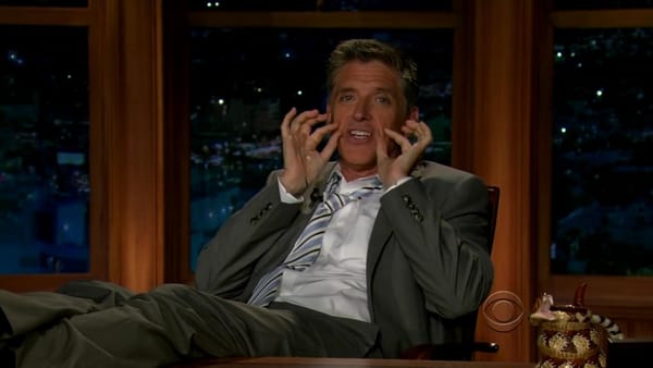 Craig Ferguson puts his legs up on the desk and pinches his cheeks