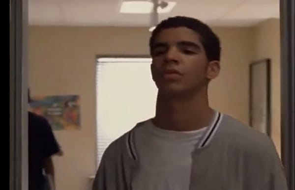 Close-up of Drake on Degrassi, in a gray letterman jacket